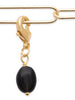 Charm, pampille perle d'obsidienne en forme d'olive fixée sur mousqueton. Plaqué or 750 millièmes. Présenté accroché sur chaîne ajourée.