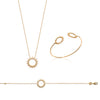 Parure SunSet, motif soleil finition perlée décliné en ras de cou et bracelet sur chaîne forçat diamantée, ainsi qu'en bracelet jonc 2 motifs. Plaqué or 750 millièmes.