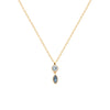 Pendentif composée de deux pierres synthétiques bleues, l'une de forme ronde, l'autre navette, serti perlé sur plaqué or 750 millièmes. Présenté sur chaine.